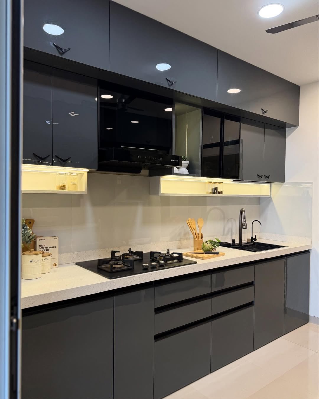Grey modular kitchen with black handles